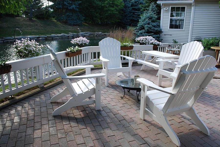 Adirondack chairs and child's picnic table shown in white