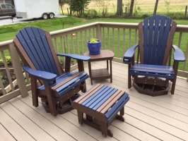 Adirondack Swivel Gliders w/Cupholders and a Gliding Ottoman, shown in Blue on Brown, and an Oval End Table Shown in Brown.