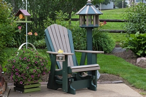 adirondack glider w/ cupholder shown in weatherwood on green